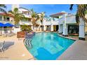 Community pool surrounded by manicured landscaping and white buildings at 10080 E Mountain View Lake Dr # 138, Scottsdale, AZ 85258
