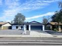 Charming single-story home boasts a well-maintained front yard, gray rock landscaping, and a two-car garage at 10815 N 65Th Ave, Glendale, AZ 85304