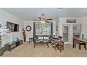 Bright living room with a ceiling fan, large window, and comfortable seating arrangement at 16013 S Desert Foothills Pkwy # 1099, Phoenix, AZ 85048