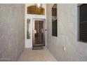 A covered entry with a decorative front door and sidelight windows provides curb appeal at 18123 W Hayden Dr, Surprise, AZ 85374