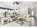 Stylish open-concept living room featuring modern decor, neutral tones, and seamless flow to kitchen at 20325 E Hummingbird Dr, Queen Creek, AZ 85142