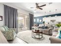 Open living space features neutral tones, modern decor, and sliding glass doors to outdoor patio at 20325 E Hummingbird Dr, Queen Creek, AZ 85142
