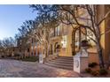 Beautiful home exterior boasts a stunning facade with an arched entrance and a well-manicured lawn at 20715 N 103Rd Pl, Scottsdale, AZ 85255