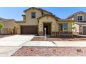 Inviting two-story home featuring a two-car garage, neutral colors, and tasteful stone accents at 20951 E Via Del Sol St, Queen Creek, AZ 85142
