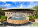 Community water feature with stone accents, waterfall, and lush landscaping at 21320 N 56Th St # 1085, Phoenix, AZ 85054