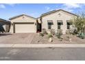 Charming home with a well-manicured front yard featuring desert landscaping and attractive curb appeal at 21432 W Minnezona Ave, Buckeye, AZ 85396