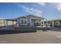 Attractive home featuring a covered carport, welcoming front porch, and well-kept yard, nestled in a serene neighborhood at 2206 S Ellsworth Rd # 50B, Mesa, AZ 85209