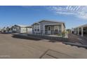 Well-maintained home with a charming front porch and manicured landscaping, set in a friendly neighborhood at 2206 S Ellsworth Rd # 50B, Mesa, AZ 85209