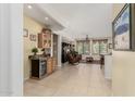 Spacious living room featuring tile floors, bar area, and comfortable seating at 26485 W Yukon Dr, Buckeye, AZ 85396