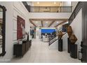 Grand foyer featuring high ceilings, decorative beams, modern staircase and stylish decor at 3307 W Storm Cloud St, San Tan Valley, AZ 85144