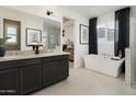 Bright bathroom featuring dual sinks, a soaking tub, and modern finishes at 3391 W Sunstone Dr, San Tan Valley, AZ 85144