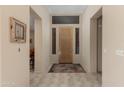 Bright foyer with a decorative front door, tile flooring, and neutral wall paint at 34435 N 68Th Way, Scottsdale, AZ 85262