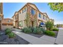 Charming townhome featuring stone accents and manicured landscaping at 4100 S Pinelake Way # 143, Chandler, AZ 85249