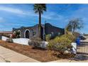 Unique home exterior featuring a well-maintained yard and black painted walls at 5222 S 5Th St, Phoenix, AZ 85040