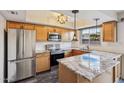 Updated kitchen featuring stainless steel appliances, granite countertops, and modern lighting at 6169 N Granite Reef Rd, Scottsdale, AZ 85250