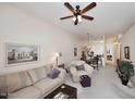 Comfortable living room showcasing an open floor plan with views into the dining area and kitchen at 6730 E Hermosa Vista Dr # 20, Mesa, AZ 85215