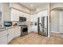 This kitchen features stainless steel appliances, neutral countertops, modern lighting, and white cabinets at 7370 E Sunset Sky Cir, Scottsdale, AZ 85266