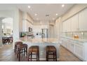 Bright kitchen with white cabinets, stainless steel appliances, granite countertops, and a breakfast bar with seating at 7370 E Sunset Sky Cir, Scottsdale, AZ 85266