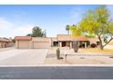 Charming single-story home featuring desert landscaping, and a three-car garage at 7820 S Maple Ave, Tempe, AZ 85284
