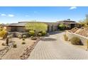 Stunning desert home with a circular driveway, native landscaping, and beautiful architecture at 8145 E Tecolote Cir, Scottsdale, AZ 85266