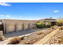 Elegant home featuring a spacious three-car garage and meticulously maintained desert landscaping at 8145 E Tecolote Cir, Scottsdale, AZ 85266