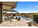 Inviting outdoor patio with a pool, lounge chairs, and desert views, perfect for relaxation and entertaining at 8145 E Tecolote Cir, Scottsdale, AZ 85266