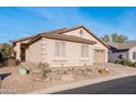 Single-story home with desert landscaping, two-car garage, and neutral stucco exterior nestled in a quiet neighborhood at 9212 E Cedar Basin Ln, Gold Canyon, AZ 85118