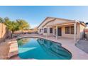Backyard pool with patio, lounge chairs, mature trees, and serene ambiance, perfect for relaxation and entertainment at 9212 E Cedar Basin Ln, Gold Canyon, AZ 85118