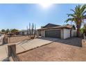 Exterior of home featuring desert landscaping and a two-car garage with a concrete driveway at 951 W La Jolla Dr, Tempe, AZ 85282