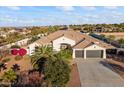 Beautiful home featuring lush landscaping, a tile roof, and a two-car garage at 10417 N 180Th Dr, Waddell, AZ 85355