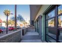 Modern condo building with glass garage door-style openings and landscaped walkway at 1130 N 2Nd St # 103, Phoenix, AZ 85004