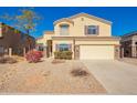 Inviting two-story home featuring a neutral color scheme, manicured landscaping, and an attached two-car garage at 1244 W Castle Dr, Casa Grande, AZ 85122