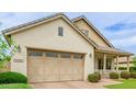 View of a well-maintained home exterior highlighting the attached garage and tidy landscaping at 14360 W Windrose Dr, Surprise, AZ 85379