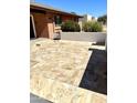 Lovely front yard featuring a decorative tiled patio and mature landscaping around the property at 1440 E Grove Ave, Mesa, AZ 85204