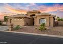 Charming single-story home boasts a two-car garage, desert landscaping and an inviting front entrance at 14728 W Cheery Lynn Dr, Goodyear, AZ 85395