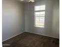 Neutral-toned bedroom with a large window providing natural light and plush carpeting at 17345 N Costa Brava Ave, Maricopa, AZ 85139