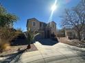 Two-story home featuring an attached garage and a low-maintenance desert landscape at 17345 N Costa Brava Ave, Maricopa, AZ 85139