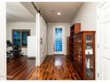 A bright foyer with wood floors and decorative glass front door at 17507 W Fetlock Trl, Surprise, AZ 85387