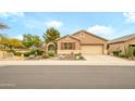 Charming single-story home featuring a desert landscaped front yard and two car garage at 17553 N Thornberry Dr, Surprise, AZ 85374