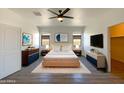 Serene main bedroom with neutral tones, a ceiling fan, and modern furnishings at 20033 N Herbert Ave, Maricopa, AZ 85138