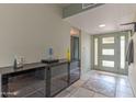 Inviting entryway with tile flooring, a decorative rug, and a stylish coat rack at 2212 W Claremont St, Phoenix, AZ 85015