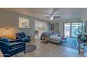 Cozy living room featuring comfortable seating, a ceiling fan, and natural light at 2212 W Claremont St, Phoenix, AZ 85015