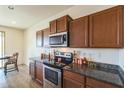 Well-lit kitchen showcasing granite countertops, stainless steel appliances, and ample wooden cabinetry at 23689 W Watkins St, Buckeye, AZ 85326