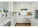 Well-lit kitchen with white cabinets, quartz countertops, subway tile backsplash, and stainless steel appliances at 2626 E Valencia St, Gilbert, AZ 85296