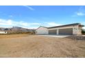 The exterior of this Arizona home features a three car garage and beautiful views of the nearby mountains at 2775 S Baker Dr, Apache Junction, AZ 85119