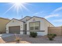 Attractive single-Gathering home featuring desert landscaping and a two-car garage at 3206 N 310Th Ln, Buckeye, AZ 85396