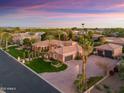 Expansive aerial view showcasing lush landscaping, and a three car garage at 3937 E Norcroft Cir, Mesa, AZ 85215