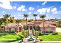 Stunning single-Gathering home featuring lush landscaping, mature palm trees, and charming water fountain at 3937 E Norcroft Cir, Mesa, AZ 85215