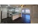 Modern kitchen with grey cabinets, granite counters, and stainless steel appliances at 4508 E Alta Vista Rd, Phoenix, AZ 85042