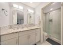 Updated dual-sink bathroom with tiled shower, decorative inset, and granite counters at 4850 E Desert Cove Ave # 333, Scottsdale, AZ 85254